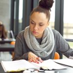woman working on paper at desk