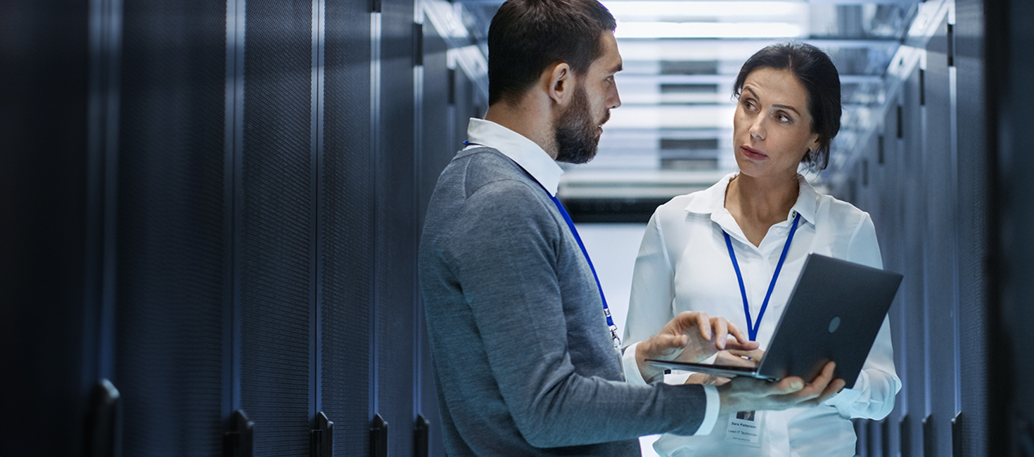 two cybersecurity professionals in a server room