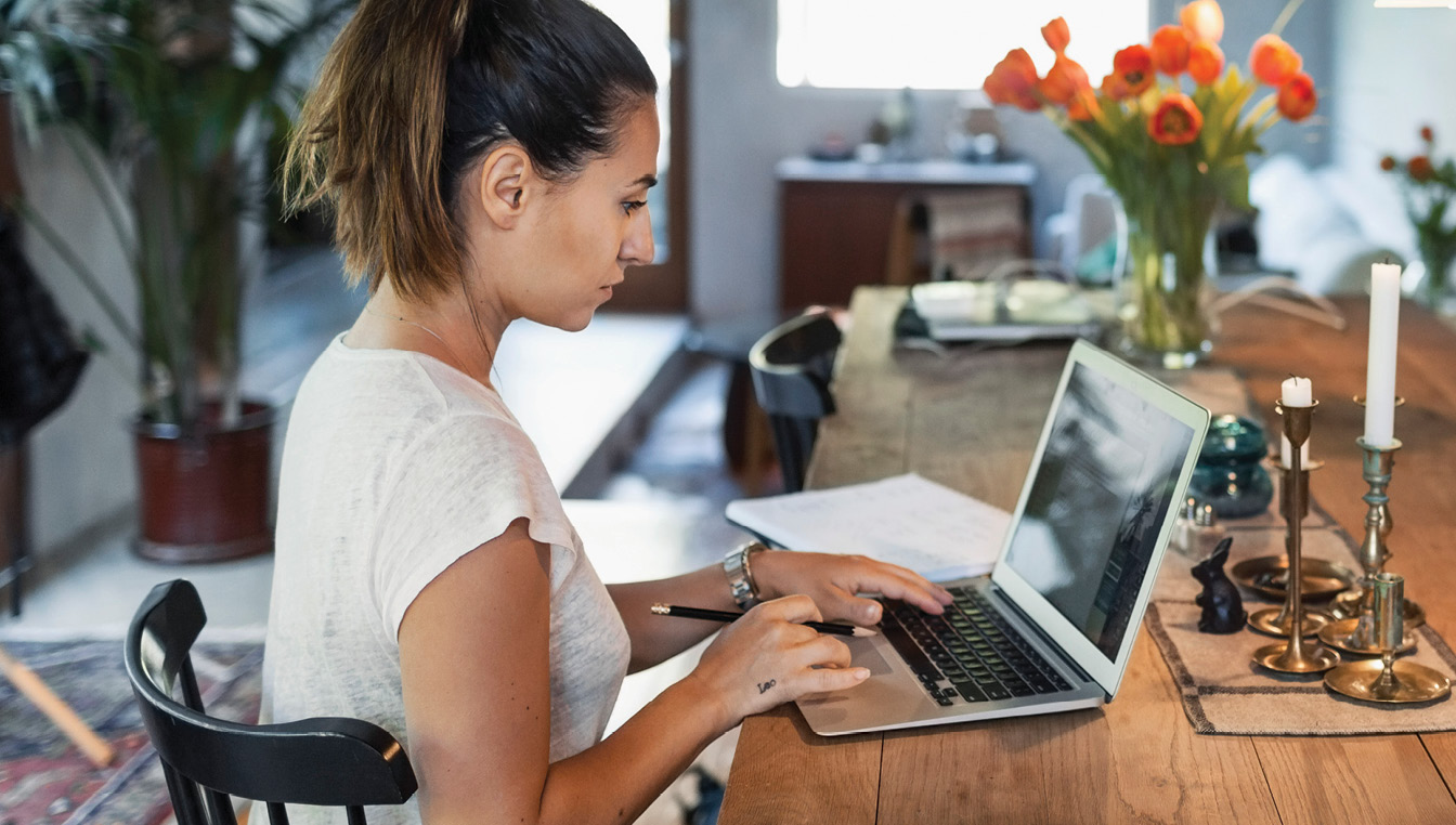 woman at computer, going back to school with GI Bill Benefits