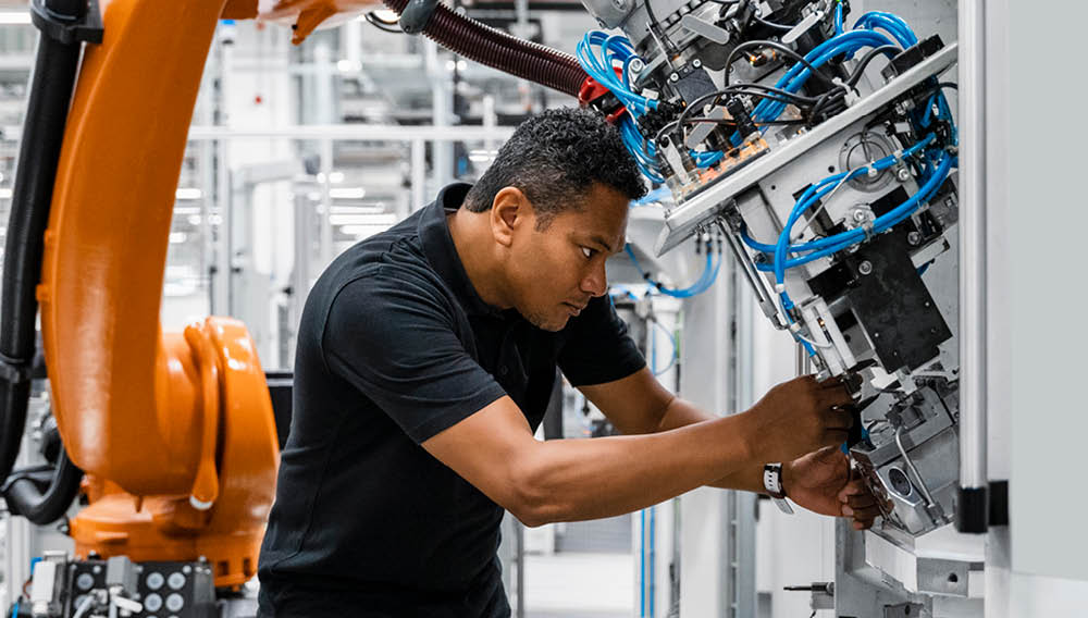 robotics technician working on machine