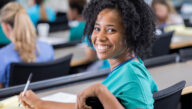 Nurse turns and smiles while taking the NCLEX
