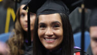 Middle-aged college graduate in cap and gown