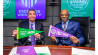 Excelsior University President David Schejbal and Hudson Valley Community College Officer in Charge Louis Coplin pose with college pennants to celebrate the institutions' expanded partnership agreement.