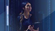 Data protection officer holding a clipboard and inspecting a server room