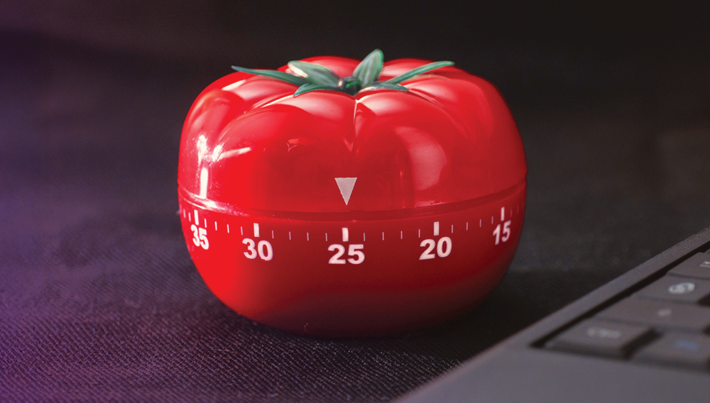 Tomato kitchen timer set to 25 minutes for the Pomodoro technique
