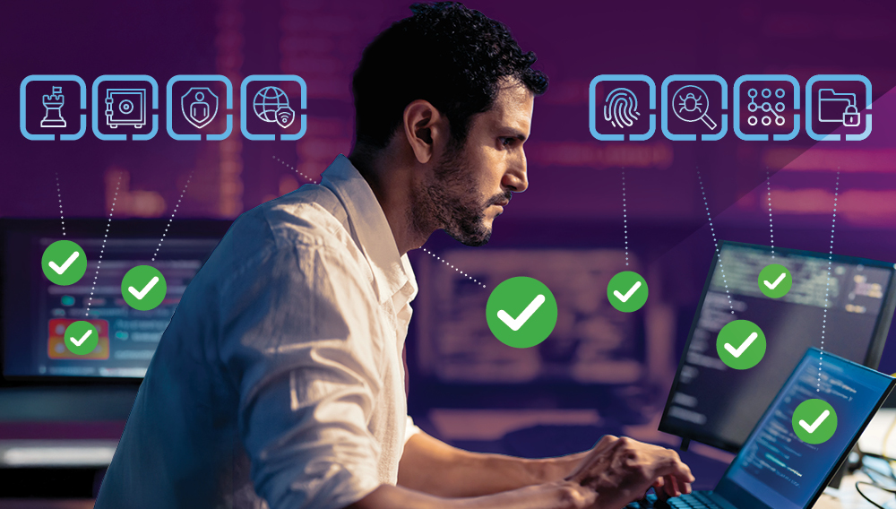 Man intensely working on multiple screens and ticking through a cybersecurity checklist