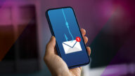 Hand holding smartphone with an email icon on the screen with a fishing hook and line attached
