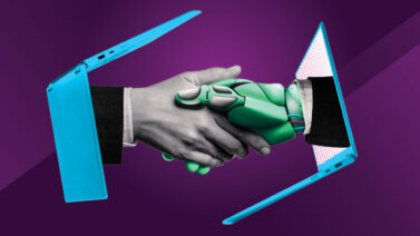 Human hand shaking a robot hand
